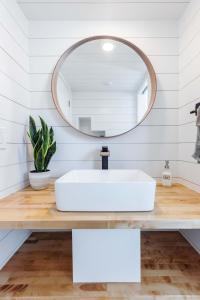 a bathroom with a white sink and a mirror at Zion Basecamp Private Hot Tub Near Trails in Apple Valley