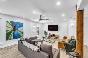 a living room with two couches and a tv at Hot Tub Fire Pit 10 Min From DFW Airport in Irving