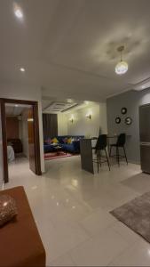 a living room with a couch and a table and chairs at nouhaila Lag in Rabat