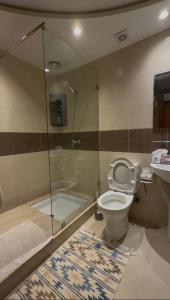 a bathroom with a shower and a toilet and a sink at nouhaila Lag in Rabat