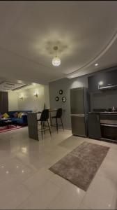a kitchen and living room with a table and chairs at nouhaila Lag in Rabat +6 photos