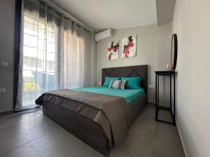 a bedroom with a bed and a large window at Villa Sunset Yerakini in Polygryos