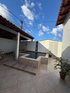 a house with a swimming pool on a patio at Casa Larissa in Presidente Figueiredo