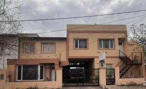 a house with a staircase in front of it at Dpto playa in Las Grutas