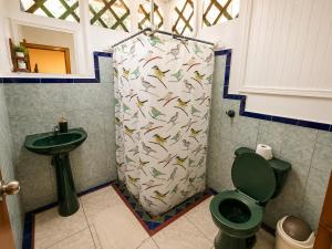 a shower in a bathroom with a toilet and a sink at Casa Dolce Vita in Puerto Viejo +20 photos