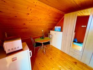 a kitchen with a small table and a refrigerator at Solaris Apartman Ráckeve in Ráckeve