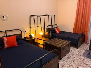 a room with two beds and a table and a room with twounks at AURY HOUSE -HistoricCenter- in Cremona