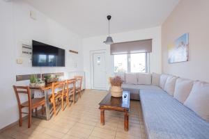 a living room with a couch and a table at Irene's Maisonette at Rafaella Resort in Kokóni