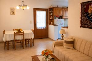 a living room with a couch and a table at Ozias House in Oziás
