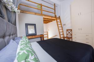 a bedroom with a bed and a bunk bed at Irene's Maisonette at Rafaella Resort in Kokóni +33 photos
