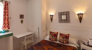 a bedroom with a bed and a table and a desk at La Estrella de Tarifa in Tarifa +114 photos