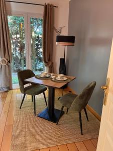 a dining room with a table and two chairs at Orée de Villevert in Senlis