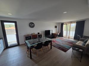 a living room with a table and a couch at Paisagem&Charme in Celorico de Basto