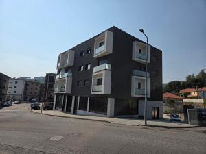 a black building on the side of a street at Paisagem&Charme in Celorico de Basto