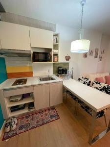 a kitchen with a sink and a table in a room at Beautiful Sandy Jomtien Beach Pattaya at NeO Seaview Condo in Jomtien Beach