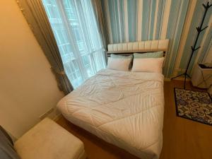 a small bed in a room with a window at Beautiful Sandy Jomtien Beach Pattaya at NeO Seaview Condo in Jomtien Beach +95 photos