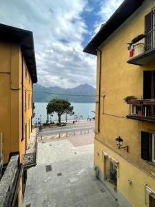 a view of the ocean from between two buildings at Bilocale fronte lago in Lovere