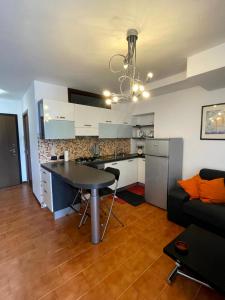 a kitchen and living room with a table and a couch at Bilocale fronte lago in Lovere