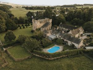an aerial view of an old castle with a swimming pool at Askham Hall in Askham