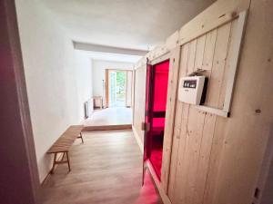 a hallway with a door and a bench in a room at Süße Wohnung im Grünen in Weiler +9 photos