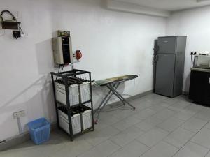 a room with a refrigerator and a table in it at Cozy Nooks in Ijaiye +1 photo
