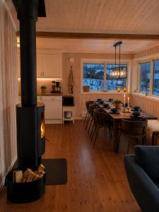 a kitchen and living room with a wood stove at Håvi Solsiden 11C in Trysil +23 photos
