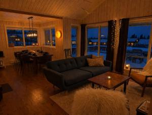 a living room with a couch and a table at Håvi Solsiden 11C in Trysil