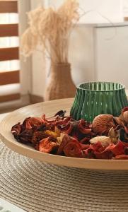 a plate of food on a table with a vase at Naša Priča Silver Lake in Veliko Gradište
