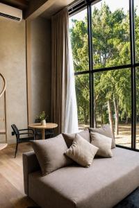 a couch in a living room with a large window at Sweven Hotel Boutique in Guadalajara