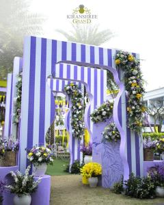a purple arch with flowers and plants on it at Kiranshree Grand in Guwahati