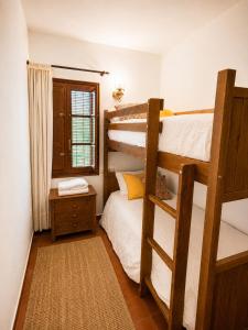 a bedroom with two bunk beds and a window at Casa Canciones in Alzira +34 photos