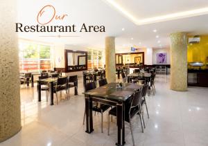 a restaurant with tables and chairs in a room at Kaslon Hotel, Garki 2 Abuja in Abuja