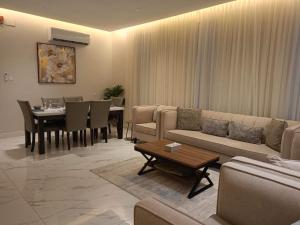 a living room with a couch and a table at استراحات وفلل رفايا in Abha