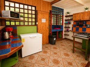 a kitchen with a white refrigerator in a room at Casa Dolce Vita in Puerto Viejo