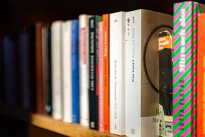 a row of books on a book shelf at Café Marie - Bed & Breakfast in Eggersdorf bei Graz