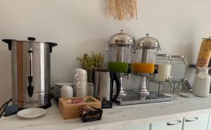 a kitchen counter with a bunch of appliances on it at Hotel Danedi in Ksamil
