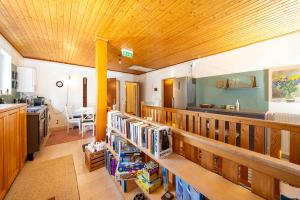 a large room with a wooden ceiling and a kitchen at Café Marie - Bed & Breakfast in Eggersdorf bei Graz