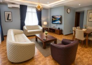 a living room with a couch and chairs and a table at Kaslon Hotel, Garki 2 Abuja in Abuja