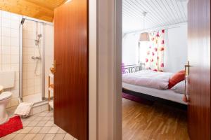 a bathroom with a bedroom with a bed and a shower at Café Marie - Bed & Breakfast in Eggersdorf bei Graz