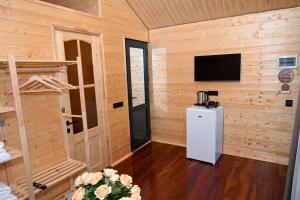 a room with a small refrigerator and a television at EKA Resort in Goris