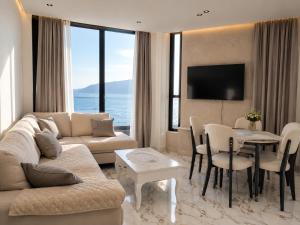 a living room with a couch and a table at IDeal Sea View Apartment in Vlorë