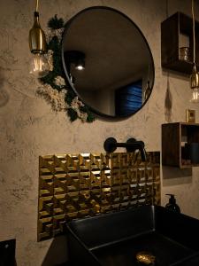 a bathroom with a sink and a mirror at Slunečná Chalet in Velké Chvojno