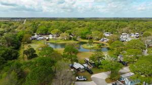 an aerial view of a park with a lake and vehicles at Road Runner Travel Resort in Fort Pierce +5 photos