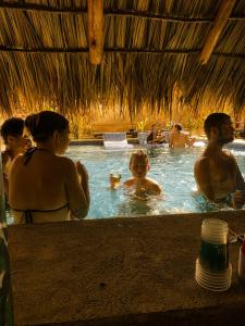 a group of people in a swimming pool at Tipsy Gypsy Bar & Hotel in Tola