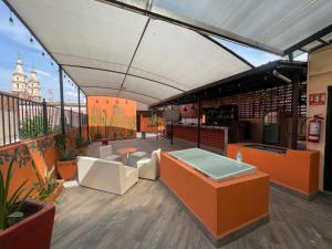 a rooftop patio with a view of a building at Hotelito Lindo León in León