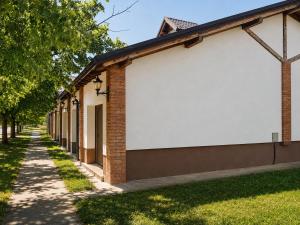 a building with a white board on the side at Semberski Salaš Intergaj Hotel in Bijeljina