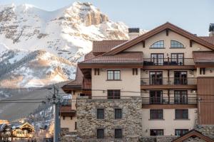a building with a snow covered mountain in the background at 5 Star Hotel - Exclusive Private Residence in Telluride