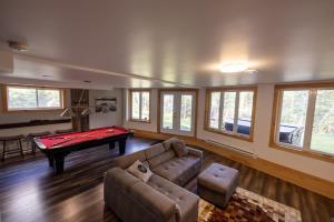 a living room with a couch and a pool table at Chinook 172 in Sainte-Marguerite