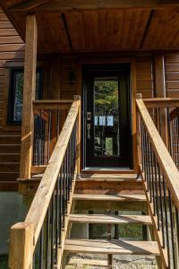 a wooden staircase leading to the front door of a cabin at Chinook 172 in Sainte-Marguerite
