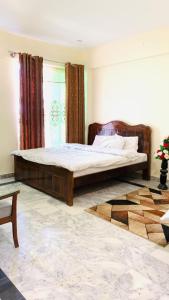 a bedroom with a large bed in front of a window at Eden Garden Resort Batakundi in Naran